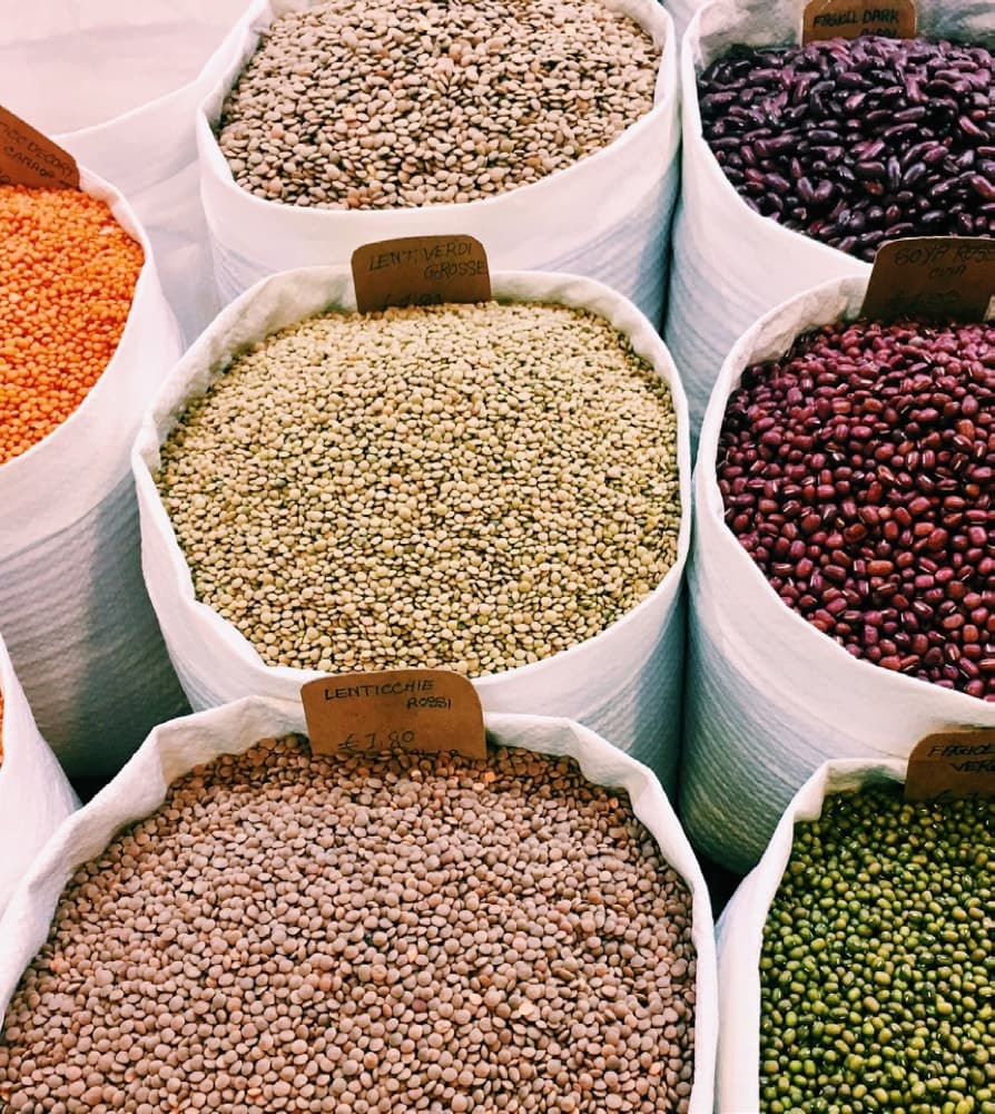 Open sacks of lentils, beans and pulses at a commodity market