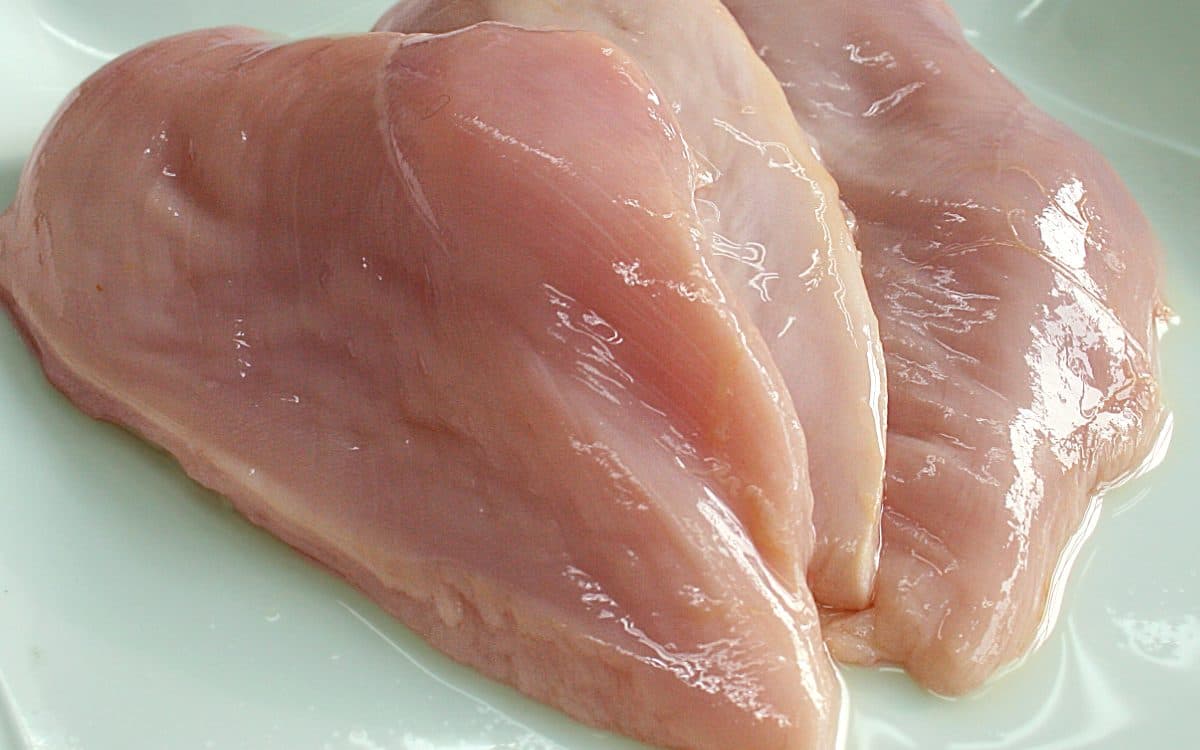 Raw boneless chicken breast portions